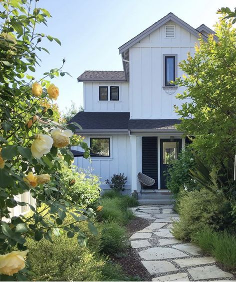 A Remodeled 1970s rancher reincarnates as a contemporary modern coastal farmhouse. The flagstone walkway leads you through a carefully edited cottage garden courtyard. Path To Front Door Cottage, Beach Cottage Front Yard, Cottage Front Walkway, Farmhouse Walkways To Front Door, English Cottage Walkway, Flagstone Walkway To Front Door, Flagstone Entryway, Cottage Paver Walkway, Front Yard Flagstone Walkway