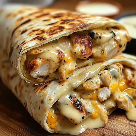 If you’re looking for a quick, easy, and flavor-packed meal, look no further than these Cheesy Garlic Chicken Wraps. ... Read more Grilled Chicken Wrap Ideas, Burrito Ideas For Lunch, Chicken Fajita Wrap Recipe, Sides For Chicken Wraps, Chicken Philly Wrap, Cream Cheese Chicken Burritos, Creamy Garlic Chicken Wraps, Garlic Parm Chicken Sandwich, Dinners For Husband