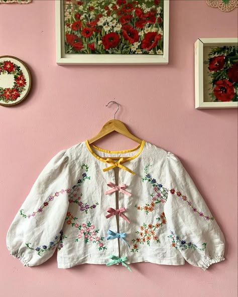 Linen floral blouse with rainbow bows 🎀 Another beauty made from vintage tablecloth with floral hand embroidery Rainbow bows on front… | Instagram Tablecloth Blouse, Upcycled Doilies, Doily Ideas, Embroidery Rainbow, Upcycle Vintage, Floral Hand Embroidery, Vintage Doilies, Rainbow Bow, Clothing Designs