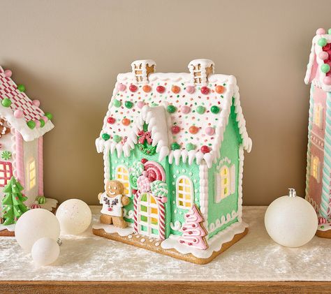 The sweetest part of the holidays? Celebrating with family and friends! But this illuminated gingerbread house -- overflowing with piped pastel details, peppermint candies, and not-so-cookie-cutter accents -- is a close second. From the Valerie Parr Hill Collection. Pastel Christmas Village Houses, Gingerbread House Pastel, Pastel Christmas Village, Rainbow Gingerbread House, Gingerbread Windmill, Painted Gingerbread Houses, Gingerbread House Ideas Decoration, Pastel Gingerbread Christmas Decor, Gingerbread House Christmas Decorations