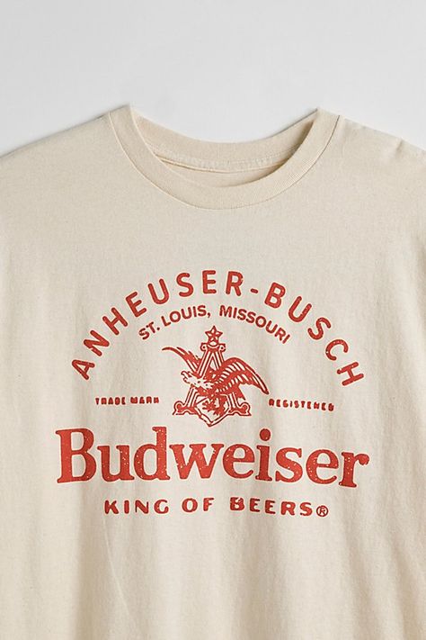 Tee with Budweiser graphics printed at the front. Cotton jersey t-shirt in a standard fit with short sleeves & a ribbed knit crew neck. Features Budweiser graphic tee Regular fit Short sleeves Crew neckline Content + Care 100% Cotton Machine wash Imported Size + Fit Measurements taken from size Medium Chest: 21" Length: 28" | Budweiser King Of Beers Tee in Ivory, Men's at Urban Outfitters Bar Shirt, College Shirts, Shirt Design Inspiration, Shirt Print Design, Graphic Tees Vintage, Graphic Tee Design, Tee Shirt Designs, Beer Shirts, Trendy Shirts