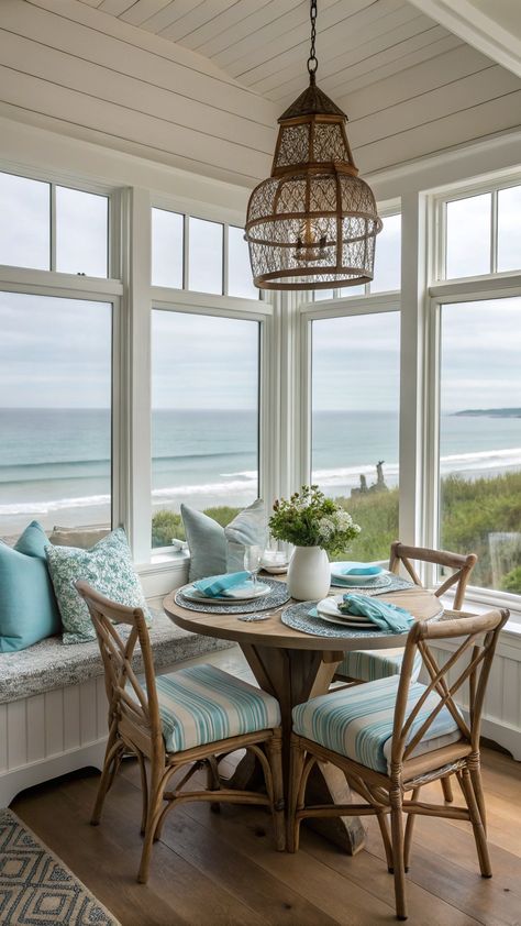 coastal farmhouse decor Table With Mismatched Chairs, Farmhouse Nook, Wrapped Chandelier, Panoramic Windows, Mismatched Chairs, Coastal Farmhouse Decor, Ocean Hues, Cozy Breakfast Nook, Cozy Breakfast