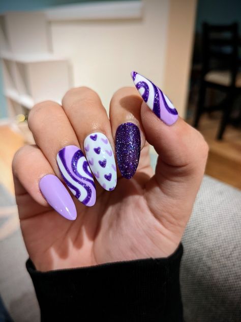 Hand showing long almond shaped nail art designs with swirls and hearts Swirly Nail Designs Purple, Nails With Pink Swirls, Swirly Nail Designs, Nail Designs Purple, Nails With Pink, Sparkle Nail Designs, Swirl Nail, Swirl Nail Art, Purple Swirl