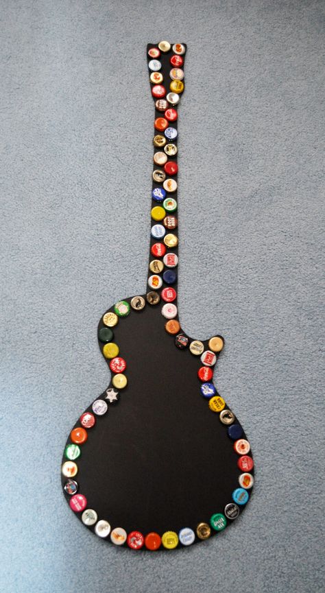 A handmade  guitar shape chalkboard, lined with tin bottlecaps; each made with different caps, making it one of a kind. Made by yours truly! :) Great for decoration, writing memos, and gifts for family or friends. If you're interested in purchasing contact me at: checkitout@ca.rr.com Bottle Cap Bar Top, Bottle Cap Guitar, Fish Bottle Cap Art, Beer Cap Crafts Diy, Diy Beer Bottle Cap Crafts Man Cave, Beer Bottle Cap Guitar, Bottle Cap Crafts Bottle Cap Co., Beer Bottle Cap Art, Diy Bottle Cap Crafts