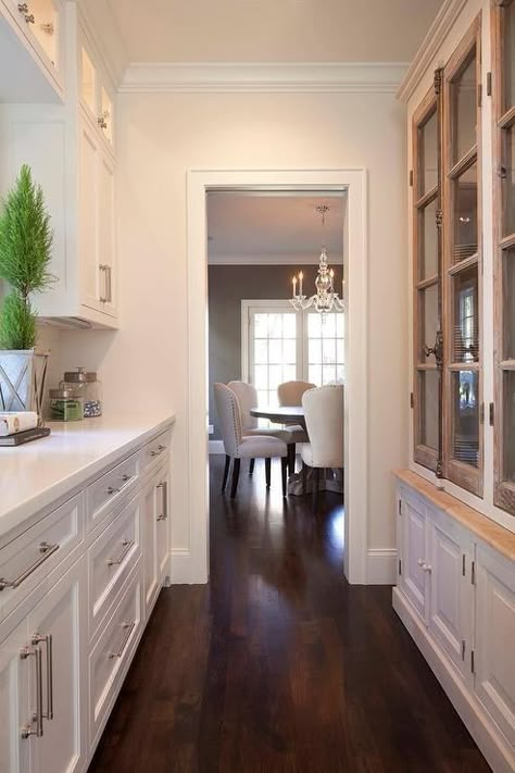 Long butler's pantry features a French glass-front casement cabinets facing a row of lit cabinets ... Butlers Pantry Walk Through, Modern White Kitchen Cabinets, Kitchen Butlers Pantry, Clean Kitchen Cabinets, Butler’s Pantry, Butlers Pantry, Butler Pantry, Butler's Pantry, Transitional Kitchen