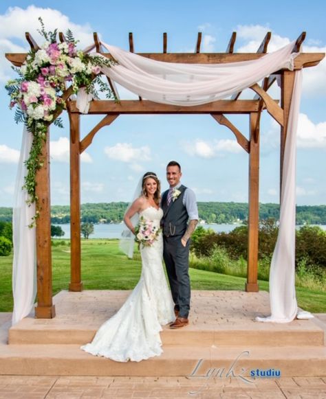 pergola with arrangements and blush chiffon drapes Wedding Pergola Decorations Outdoor, Pergola Ceremony Decorations, Ceremony Pergola, Pergola Drapes Wedding, Decorating A Pergola For A Wedding, Wedding Pergola Draping, Pergola For Wedding, Pergola Wedding Decor, Pergola Wedding Ideas