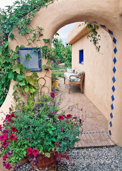 Susan Blevins of Taos, New Mexico, created an elaborate home garden featuring containers, perennial beds, a Japanese themed path and a regional style that reflects the Spanish and pueblo architecture of the area. A stucco portal lined with vines adds a mystical air. Pueblo Architecture, Adobe Homes, New Mexico Style, Base Ideas, New Mexico Homes, Garden Magic, Taos New Mexico, Mexico Style, Garden Vines