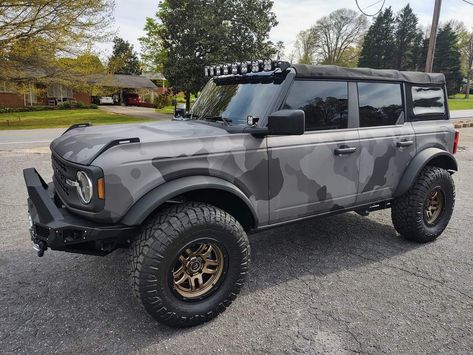 This Ford Bronco just got a whole new level of swag with the Metro Wrap Elite Black Camo! 🖤🖤🖤 Shoutout to the awesome folks at BMB Supply Company for this super sick wrap! 🤩 #metrorestyling #alwanwraps #kingsofvinyl #automotive #paintisdead #cargram #vinylwrap #carwrap #carwrapping #vinylwrapping Camo Wrap Truck, Camo Vans, Camo Truck, Truck Wrap, Camo Wraps, White Truck, Van Wrap, Take The High Road, Cars 3