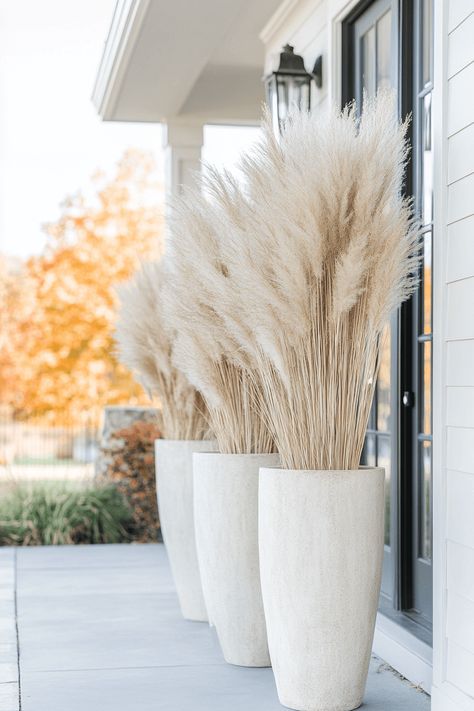 tall concrete planters with pampas grass on a front porch Pompass Grass Tall Floor Vase, Grass In Planters, Tall Concrete Planters, Tall Pampas Grass Decor, Wooden Outdoor Table, Table Fall Decor, Fall Front Porch Ideas, Grass Wreath, Ornamental Kale