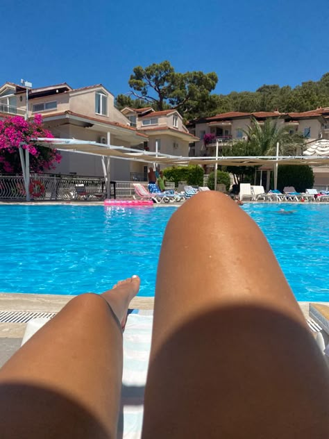 Tanned legs on a sunbed, sat beside an outdoor swimming pool in Turkey Sunbed Aesthetic, Sunbathing Aesthetic, 2025 Board, My Highest Self, Holiday Pics, Holiday Aesthetic, Summer Tanning, Highest Self, Summer 2025