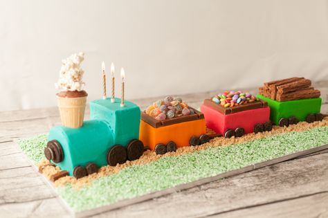 This cute train cake is assembled using store bought cake, and if you like, store bought frosting. Although, we’ve included a recipe for our favourite vanilla buttercream because it’s simply delicious, and of course, you could bake your own Madeira loaves if you wanted to. Get the full recipe here http://www.ilovecooking.ie/recipe/train-cake/ Train Birthday Cake, Train Cake, Store Bought Cake, Trains Birthday Party, 3rd Birthday Cakes, 2 Birthday Cake, Toy Trains, Train Party, Train Birthday