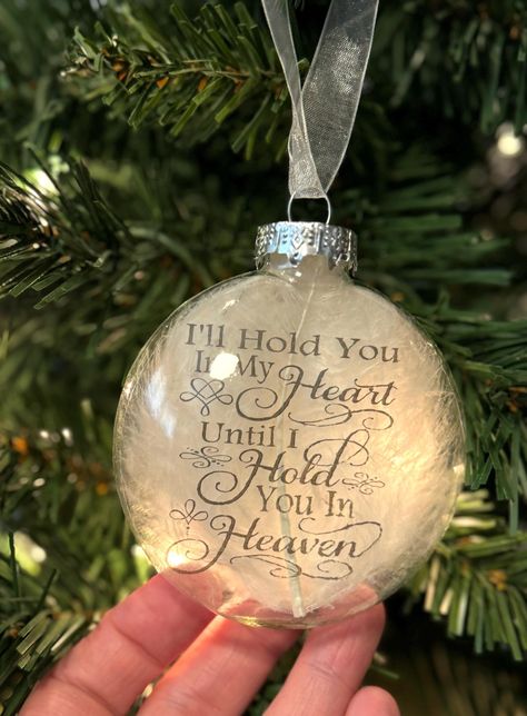 This is a round puffed flat glass ornament that measures approximately 3.15" in diameter, with a white feather behind a transparency with the words, "I'll hold you in my heart until I hold you in Heaven" on the inside of the ornament. The ornament hangs from white organza ribbon. Makes a beautiful memorial for your lost loved one. Comes in a small box for safe keeping. Quick link back our store's homepage: http://www.etsy.com/shop/HeartProjects?ref=pr_shop Find us on facebook for new listings an In Memory Christmas Ornaments, Memory Ornaments, Mom Memorial, Dad In Heaven, Ornament Ideas, White Feather, Memorial Ornaments, Organza Ribbon, Glass Blocks