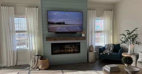 Their Second Touchstone Fireplace Installation -- Erika’s parents recently moved into a newly built home and wanted to add a fireplace in the living room. Already fans of Touchstone’s easy-to-install electric fireplaces, Erika and her dad chose the Sideline Elite as the focal point. Erika shares, “This fireplace is seriously stunning - the flames and logs are so realistic!" Read More on the Blog: https://bit.ly/4aSxc3K Modern Coastal Fireplace, Large Electric Fireplace, Fireplace Accent Wall, Fireplace Installation, Coastal Fireplace, Fireplace Accent Walls, Fireplace Feature Wall, Tv Lift Cabinet, Recessed Electric Fireplace