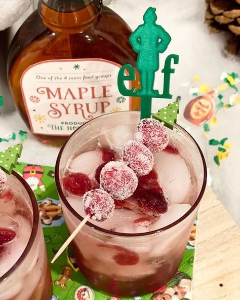 CELEBRATE YOU EVENT DESIGN & PLANNING on Instagram: "I’m doing it. I’m going to toot my own horn here. I’m super proud of this cocktail! I give you the Cranberry Maple Bourbon Elf-tail. Makes 2: 2 T cranberry sauce 2 oz Bourbon 1 oz maple syrup 1/2 oz Grand Marnier Club soda Shake the first 4 ingredients together and pour into cup with ice. Top with club soda! I hate wasting food, so I wanted to find a way to use my cranberry sauce from thanksgiving. I also wanted to play on the Elf movie Elf Movie Themed Cocktails, Buddy The Elf Drink, Elf Cocktail, Elf Movie Party, The Elf Movie, Elf Themed Christmas Party, Syrup Labels, Maple Bourbon, Christmas Movie Night