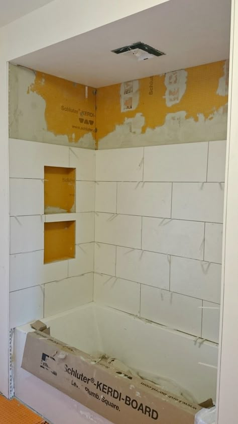 Schluter Kerdi Shower Cubby Installed Shower With Soffit, Kerdi Shower Niche, 12x24 Tub Surround Tile, Schluter Shower Niche, Large Format Tile Tub Surround, Schluter Shower System, Shower Cubby Ideas, Schluter Tile Edge Showers, Schluter Niche