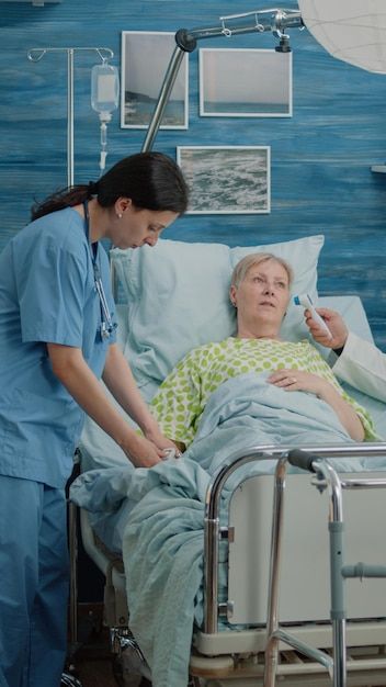 Premium Photo | Old woman with sickness getting consultation from nurse and doctor in nursing home. retired patient laying in hospital bed while medical team doing checkup visit for recovery examination In Hospital Bed, Health Ads, Happy Emotions, Couples Play, Feeling Excited, Hospital Bed, New Photo Download, Digital Tablet, Positive People