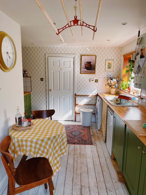 Sun shining into kitchen with floral wallpaper, green cabinets, red rug, small kitchen table with yellow gingham table cloth. Windowless Kitchen, 1940s Kitchen, Cosy Interior, Cozy Kitchen, Dream House Rooms, House Room, Pretty House, Dream House Decor, House Inspo