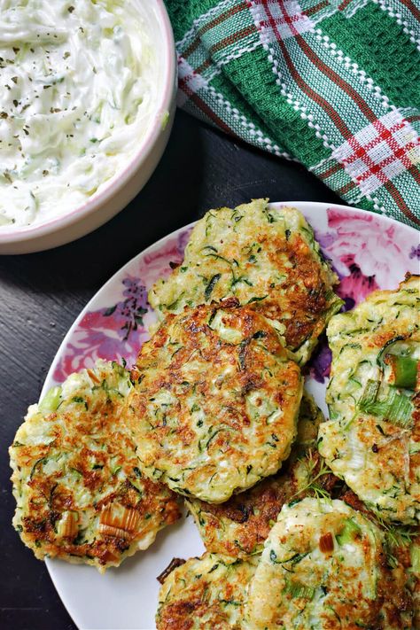 Greek Courgette Fritters with feta, or Kolokithokeftedes, a delicious and healthy summer appetizer that is quick and easy to make with fresh seasonal ingredients. The fritters are shallow fried for a crispy texture, and are served with a refreshing tzatziki sauce. Delicious Beef Stew, Courgette Fritters, Greek Meze, Courgette Fritter, Tasty Beef Stew, Greek Appetizers, Veggie Patties, Cheese Plates, Summer Appetizer