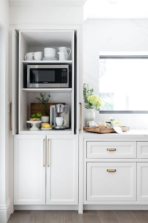 Kitchen coffee station hidden by fold-in white shaker cabinet pocket doors. Kitchen Drink Bar Ideas, Ikea Coffee Bar, Office Kitchens, Kitchen Coffee Station, Shaker Style Cabinet Doors, Coffee Station Kitchen, Cottage Kitchen Design, Home Coffee Stations, Messy Kitchen