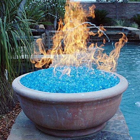 A fire pit using "fire glass." Our local recycle center crushes all glass bottles they receive, yielding a colorful, pebbly mix...and they give it away to the public. Yet another project... Have Inspiration, Fire Glass, Kit Home, Cool Stuff, Tiny Homes, Outdoor Projects, A Fire, Garden And Yard, Real Wood