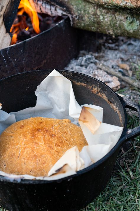 This simple loaf is baked in a Dutch oven and produces a moist crumb with a crisp exterior. Minimal prep and mess make this an excellent camping bread. Making Bread Over A Fire, Dutch Oven Bread Campfire, Campfire Bread Dutch Ovens, Camp Fire Bread, Dutch Oven Bread Camping, Baking Bread In Dutch Oven, Bread Over Fire, Camp Bread, Camping Bread