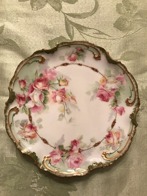 There is a touch of yellow. Edges are scalloped and trimmed with hues of greens. Hand painted and has gold on the edges and some on the inter section of the plate. | eBay! Pretty China, Antique Dishes, Hand Painted Roses, Antique Plates, Porcelain Pottery, Limoges Porcelain, Porcelain China, China Painting, Porcelain Art