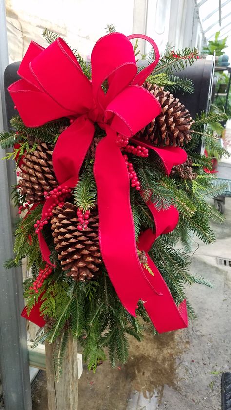 This large Mailbox Saddle has an oasis cage on either side filled with freshly cut Fraser Fir, Cedar, Winterberry and pinecones. We've added a wired red velvet bow on either side - because this mailbox has the name and number on-top. Follow us on Facebook: https://www.facebook.com/andysgardencenter/ and Instagram: https://www.instagram.com/andyscreekside Mailbox Saddle, Beautiful Mailbox, Large Mailbox, Fraser Fir, Attract Pollinators, Landscape Services, Velvet Bow, Landscape Trees, Garden Supplies