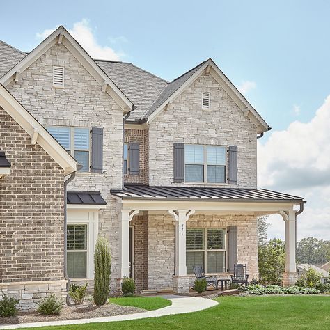 The combination of stone and brick is one that never gets old! We are loving the light stone paired with dark brick on this home's exterior. Featured stone: Handcrafted series in the color Hermitage Light Brick Houses Exterior, Stone Brick Exterior House, Brick And Stone Farmhouse Exterior, Stone Exterior Houses French Country, Stone Exterior Ranch Style Home, Stone And Brick House Exterior Farmhouse, Brick Options Exterior, Light Brick And Stone Exterior, Brick And Rock Exterior Combinations