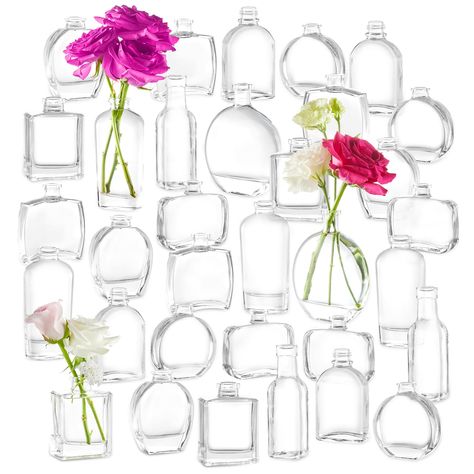 PRICES MAY VARY. Perfume Bottle Inspired Design: This 33pcs glass small bud vases set includes 9 different styles of clear bud vases, suit for any occasion. They are a beautiful decorative accent for windowsills, dining tables, and as wedding centerpieces. Versatile Use: These flower vases are not just for fresh flowers, they can hold silk or dried flowers, greenery, branches, feathers, or even essential oils. Not only can you use these vases for flowers, but they also look great as perfume bott Whimsical Centerpieces Table Decorations, Bud Vases Centerpiece Long Table, Round Table Centerpieces Wedding Simple Floral Arrangements, Bud Vases For Wedding, Round Table Centerpieces Wedding, Small Bud Vases, Round Table Centerpieces, Spring Centerpieces, Bud Vase Centerpiece