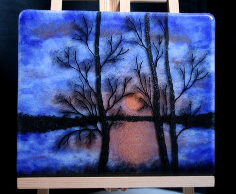 'Midsummer's night' The setting sun disappears over the horizon silhouetting the trees, whilst the last vestiges of Midsummer's sunset glows across the lake and skies. A tranquil, peaceful, scene to give a relaxing air to your special space. Three dimensional fused art glass painting featuring a background layer of the lake, setting sun and a horizon of woodland. It has a silhouette of trees and grasses on the front layer. Hard to show in the photos but the 3D, dual layers give the piece depth and character not usually found in 'flat' paintings. I painstakingly painted each layer by hand, kiln fused them separately and then, when I was happy with them both, I kiln fused the two layers together to give a three dimensional look that draws you into the picture. Can be purchased with the easel Fused Glass Sunset, Stained Glass Light, Painting Glass, Fused Glass Artwork, Zentangle Designs, Panels Wall, Red Sunset, 3d Painting, Glass Artwork