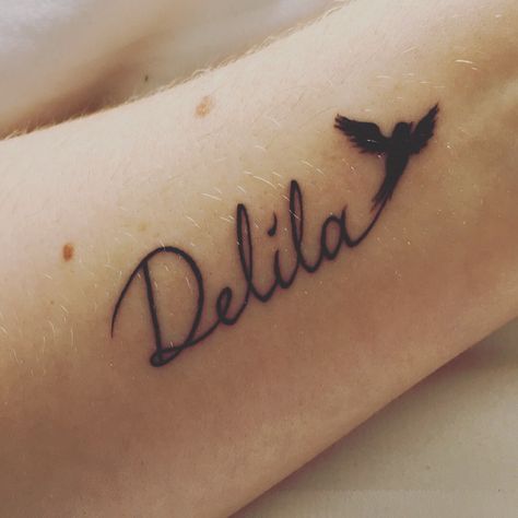 My first tattoo, Delila and a blackbird after her favourite Beatles song. Daughter tattoo, name tattoo, script, first ink Daughters Name Tattoo, Sisters Tattoo, Daughter Tattoo, Script Tattoo, Tattoo Name, Anchor Tattoos, Beatles Songs, Tattoo Script, Tattoos For Daughters