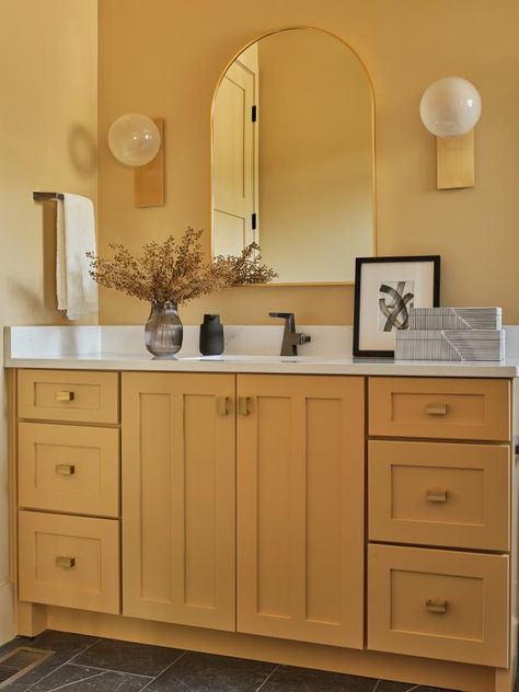 Golden yellow tones and natural wood combine in the guest room bathroom for a stylish, modern space where guests can refresh themselves and start the day. Sunny Bathroom, Hgtv Dream House, Cheap Bathroom Makeover, Upstairs Bathroom Ideas, Florida Bathroom, House In The Hills, Hgtv Dream Homes, Yellow Cabinets, Palm Springs House