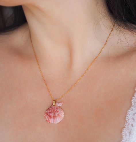 ༄ This 𝗣𝗶𝗻𝗸 𝗦𝗰𝗮𝗹𝗹𝗼𝗽 𝗦𝗵𝗲𝗹𝗹 necklace is more than just jewelry; it’s a wearable reminder of the ocean’s wonders.🐚🩷🌊 The gold necklace is adorned with a beautiful pink colored 𝗩𝗮𝗿𝗶𝗲𝗴𝗮𝘁𝗲𝗱 𝗦𝗰𝗮𝗹𝗹𝗼𝗽 𝗦𝗵𝗲𝗹𝗹, found by me on the beach of Algarve, Portugal. The unique pattern and pink hues of this 𝗩𝗮𝗿𝗶𝗲𝗴𝗮𝘁𝗲𝗱 𝗦𝗰𝗮𝗹𝗹𝗼𝗽 𝗦𝗵𝗲𝗹𝗹 show to the rich coastal colors found along coastline of Portugal. 🐚 Variegated Scallop Shell || Mimachlamys varia ▼ Stainless Steel ▼ Length: 45 cm with extend option to 50 cm. ... Pink Shell Necklace, Coastal Colors, Scallop Shell, Algarve Portugal, Scallop Shells, Shell Art, Shell Necklace, Ocean Inspiration, Shell Necklaces