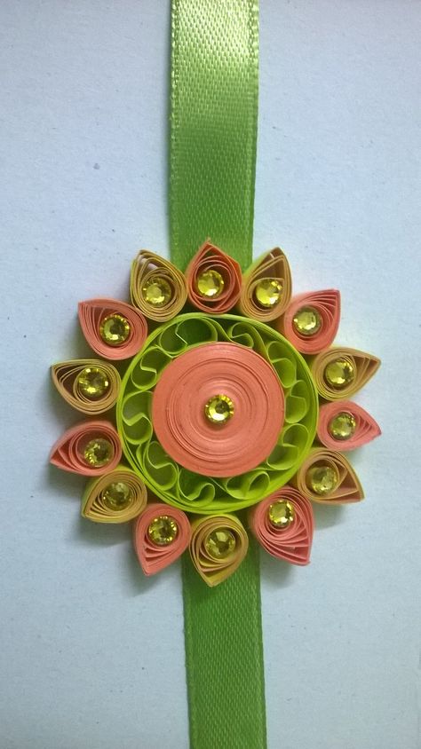 Quilling rakhi Big Rakhi For Decoration, Quilling Rakhi Ideas, Rakhi Competition Ideas Creative, Quilling Rakhi Handmade, Rakhi Making Competition, Rakhi Designs Handmade, Quilling Rakhi, Quilling Arts, Handmade Rakhi Designs