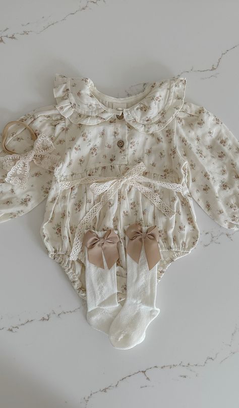 Indulge your little one in the luxurious comfort of our Mabel Cotton Romper. Crafted from light muslin cotton, this delightful romper features a dainty floral print and a delicate lace tie. With long sleeves and a trimmed collar, this romper is perfect for any occasion. Front buttons make dressing your baby a breeze. Baby Stuff Aesthetic, Baby Girl Vintage Outfits, Aesthetic Baby Clothes, Baby Clothes Aesthetic, Cottagecore Baby Clothes, Cute Embroidered Cotton Bubble Romper, Spring Cotton Bubble Romper With Lace Trim, French Baby, Lace Tie