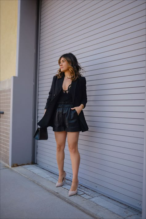 Today CHIC TALK is sharing this chic total black look. She bought the body suit from @freepeople and paired it with faux leather shorts and a black blazer. This outfit is perfect for your next date night or girls night out! Follow for more summer outfit ideas, elevated fashion, and style guides. Black Shorts Outfit Dressy, Leather Shorts Night Outfit, Black Shorts With Blazer Outfits, Black Suit Shorts Outfit, Faux Leather Shorts Outfit Going Out, Leather Shorts Blazer Outfit, Leather Shorts And Blazer Outfit, Going Out Shorts Outfit Night, Faux Leather Shorts Outfit Summer