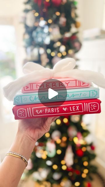 Pippi Post | Bookish Merch ✨ on Instagram: "Book stack gift wrap! ✨

I might be wrapping all my gifts like this for Christmas! 

I love that the present “spines” double as a gift tag and the big fluffy yarn bow is the cherry on top! 

I gathered up all the links to my favorite markers and wrapping paper for you! Comment GIFT below and I’ll send you the links! 👇

#christmasgiftwrapping #pippipost #bookishmerch #bookishshop #bookmerch #writelikepippi #christmaswrapping #christmaswrappingideas" Wrap Christmas Books, Fluffy Yarn, Bookish Merch, Book Stack, Colorful Christmas, Wrapping Ideas, Cherry On Top, Stack Of Books, Holiday Decorating