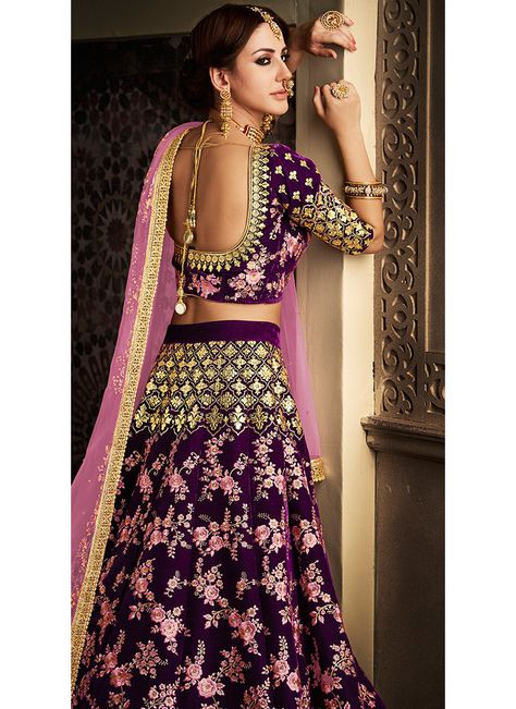 Purple and Pink Embroidered Lehenga features a beautiful velvet blouse with a velvet skirt alongside a net pallu. Embroidery work is completed with zari, thread, and stone. Blouse Designs Velvet, Purple Blouse Designs, Velvet Wedding, Indian Sari Dress, Sari Dress, Indian Sarees Online, Lehenga Choli Online, Embroidered Lehenga, Lehenga Collection