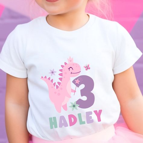 This pink dinosaur birthday shirt will be so cute for your girl's dinosaur birthday party!  It would be perfect for a three rex themed party!   The Bella Canvas short sleeve tee for toddlers is a 100% Airlume combed and ring-spun cotton jersey with a tear-away label for extra comfort .: 100% Airlume combed and ringspun cotton  .: Extra light fabric (3.9 oz/yd² (132 g/m .: Tear-away label HOW TO ORDER: Please follow these 4 simple steps: 1. Select the size you want in the "Size" option. 2.Follow Three Rex Shirt, Pink Dinosaur Party, 3rd Birthday Shirt, Girl Dinosaur Birthday, Girls 3rd Birthday, Dino Shirt, Baby Birthday Themes, 2nd Birthday Shirt, Girl Dinosaur