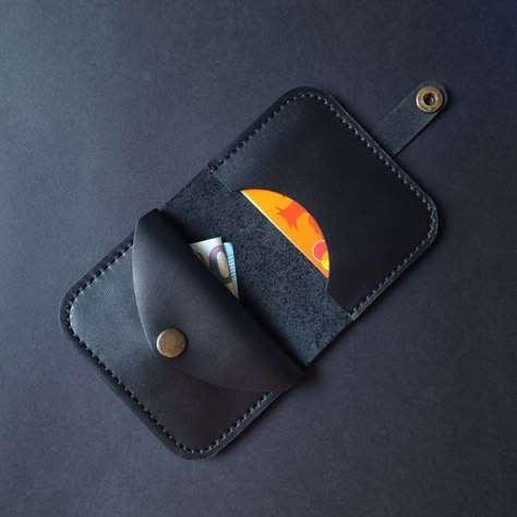 The black leather wallet is a mini wallet for carrying a few banknotes, some coins and your favorite cards. The wallet is handstitched and it has a snap closure in the brass metal color. The wallet is made of nappa leather, which is characterized as one of the most widely used types of leather. The surface of this leather is very smooth and even. Scratches are possible over time but, in general, this leather is quite scratch-resistant and you should find a very sharp tool to scratch it.  Over ti Leather Patterns Templates, Leather Bag Tutorial, Small Leather Wallet, Black Leather Wallet, Leather Card Holder, Clip Wallet, Leather Projects, Leather Pieces, Money Clip Wallet