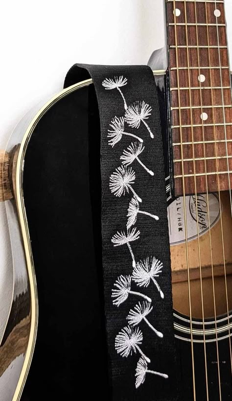 "If you like your accessories to be eye-catching and unique, then this embroidered dandelion clocks design is the guitar strap for you! Each strap is made to order with your choice of strap colour and thread. Strap Features: * suitable for electric, acoustic or bass guitars * adjustable length from 27\"-49.5\" so suitable for adults and children * 2\" durable soft webbing with PU leather ends * comfortable design means that the strap will stay in place and won't slide off or dig into your should Diy Guitar Design, Embroidered Guitar Strap Diy, Custom Guitar Strap, Guitar Strap Diy, Guitar Straps Diy, Embroidered Dandelion, Clocks Design, Black Acoustic Guitar, Acoustic Guitar Strap