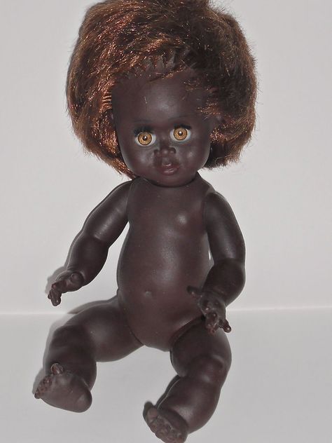 Vintage Early 70's Australian Aboriginal Doll ' PICANINNY" by METTI 6.63+4 10'' tall and made of vinyl with thick rooted hair with a two tone look to it, orange coloured sleep eyes with very long eyelashes  She is a bent limbed baby and is jointed at the arms and legs  She would have come wearing a little red nappy/sarong type thing and a little boomerang with 'Picaninny' marked on it.  She has a sister 'Bindi' which I unfortunately sold a few months ago. Sleep Eyes, Long Eyelashes, Longer Eyelashes, Sarong, Little People, Eyelashes, Two Tone, Sleep, Australia