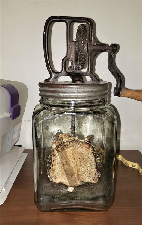 "This is a Daisy Churn #40.  Made by the Daisy Manufacturing Company of St. Louis MO 1922. This particular churn does not have a screen in the lid. It has 2 nicks around the rim of the jar. Very clean. The glass is of the period where you still see the little bubbles in the glass.  The paddles are original. Height is 14 inches height. Width is 6 inches. This was in a trunk that was purchased by bid at an auction. It is a genuine find for that collector that appreciates kitchen antiques. Research of item: Butter churns recall simpler times and down-home pleasures. Sweet butter produced from hours of hand labor was the pride and joy of many an old-time farm. Butter churns work on the simple principle that agitating cream eventually turns it into butter. The most well-known kind of churn was Butter Churner, Antique Butter Churn, Butter Churns, Vintage Kitchen Gadgets, Antique Crocks, Wooden Staff, Butter Churn, Large Tub, Butter Molds