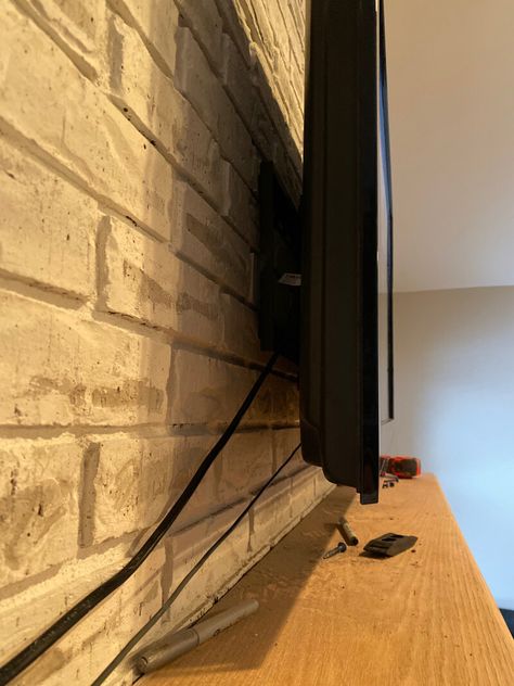 How to Mount a TV Over a Brick Fireplace - Hide Tv Cords Above Fireplace, Hiding Wires Mounted Tv, Hiding Tv Cords On Wall, Above Fireplace Ideas, Hide Tv Cords, Tv Above Fireplace, Fireplace Tv Mount, Tv Cords, Dollar Diy