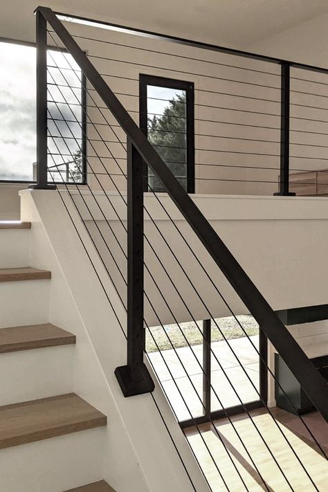 Stair Railing Ideas Black Metal, Metal Rails For Stairs, Modern Wire Railing, Indoor Steel Railings For Stairs, Black Stairs And Railing, Modern Interior Railing Ideas, Modern Black Metal Stair Railing, Black Cable Railing Interior, Cable Handrails For Stairs