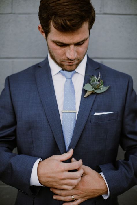 Handsome groom in dark navy suit getting ready before the ceremony. Navy blue suit looks good paired with light blue tie. #navysuit #groomattire #smokyhollowwedding Light Blue Tie With Navy Suit, Blue Suit Blue Tie Wedding, Navy Blue Suit Light Blue Tie, Tie With Navy Blue Suit, Navy Suit With Blue Tie, Dark Navy Blue Groomsmen Suits, Dark Blue Suit With Light Blue Tie, Groomsmen Blue Tie, Navy Suit Light Blue Tie