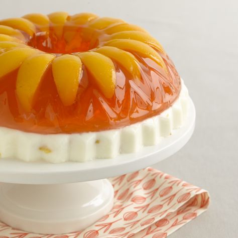 Peaches and Cream- this retro treat is made with a layer of sweetened condensed milk topped with peach gelatin and sliced peaches (with an option to add a little schnapps to the top layer if you like) Layered Jello Mold Recipes, Jello Deserts, Peach Jello, Jello With Fruit, Jello Mold Recipes, Jello Dessert Recipes, Gelatin Recipes, Jello Cake, Busy Kitchen