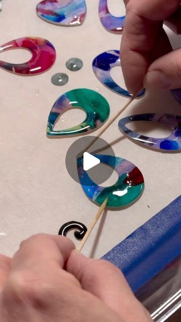 Becky Peach on Instagram: "I get asked how the resin stays on the watercolor cutouts. It’s mostly surface tension magic and fine detail with toothpicks. #watercolorjewelry #resin #resinprocess #behindthescenes" Epoxy Resin Jewelry, Watercolor Jewelry, Surface Tension, Shower Tile Designs, Bead Sewing, Gold Line, Epoxy Resin, Shower Tile, Resin Jewelry