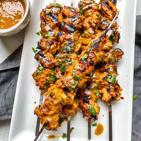 Fire up the grill with these Thai Curry Chicken Skewers! Juicy, flavorful chicken paired with a creamy coconut peanut sauce makes the perfect dish for any BBQ or dinner. Ready in no time and packed with exotic Thai flavors! Chicken Skewers Dinner, Thai Curry Chicken Skewers, Thai Chicken Skewers Grilled, Grilled Thai Coconut Chicken Skewers, Thai Coconut Chicken Skewers, Thai Chicken Meatballs With Peanut Sauce, Thai Appetizers For Party, Thai Food Appetizers, Thai Chicken Tenders