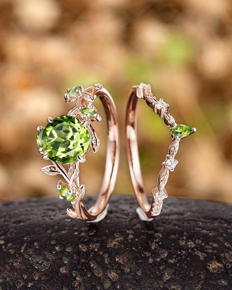 ► FEATURES This ring set is handmade by me. vintage round cut peridot with moissanite accents, it is vintage and dainty. Engagement Ring: Center Stone:  1.3Ct Peridot Size: 7mm Round cut  Side Stone: 0.2 carat Marquise Peridot *Band Width : 1.6-1.7mm Wedding band: Accent Stone:  0.1Carats Round Moissanite 0.1Carats  Pear Peridot *Band Width (Bottom): 1.6-1.7mm The center stone of the ring can be replaced with other different kinds of gemstone such as morganite, aquamarine, amethyst, citrine, opal, moissanite, alexandrite, moss agate, etc. If you want to customize your own personal ring, please feel free to contact me. ► PROCESSING & SHIPPING Processing time: 3 to 4 weeks after placing order, International Buyers Please Note: In some cases, additional custom fees and duties may be charged, Unique Emerald Wedding Rings, Romantic Style Engagement Rings, Engagement Rings Peridot, Peridot Crystal Ring For Wedding, Wedding Peridot Birthstone Rings, Peridot Crystal Wedding Ring, Wedding Ring With Hallmarked Peridot, Hippie Wedding Ring, Green Peridot Rings With Nature-inspired Style